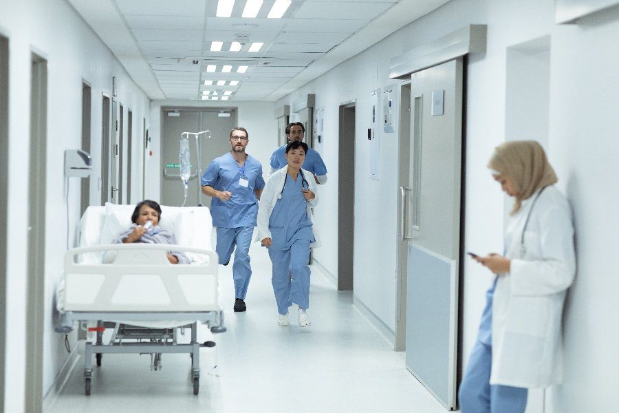 nurses running down hospital corridor